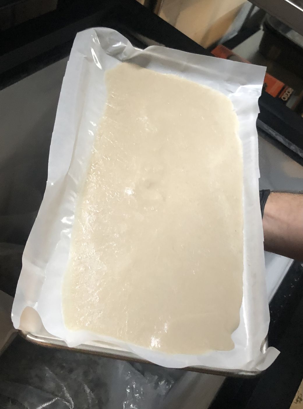 A tray of fresh ice water hash drying on parchment